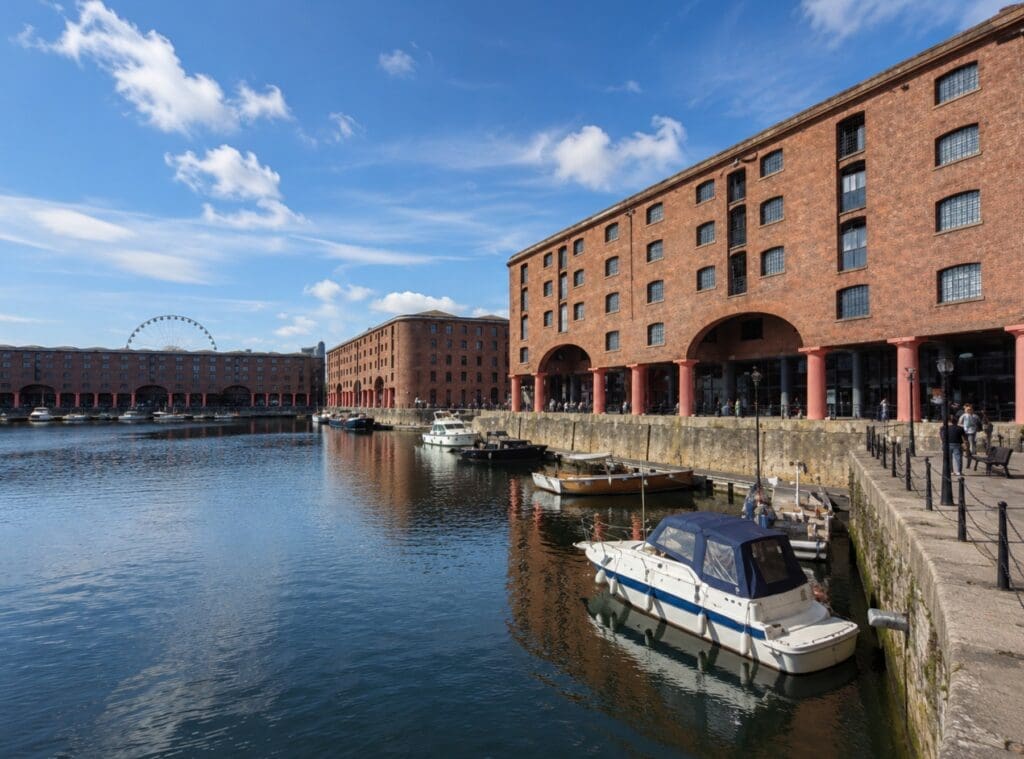 Royal Albert Dock during the day, with water, brick warehouses and people at a distance