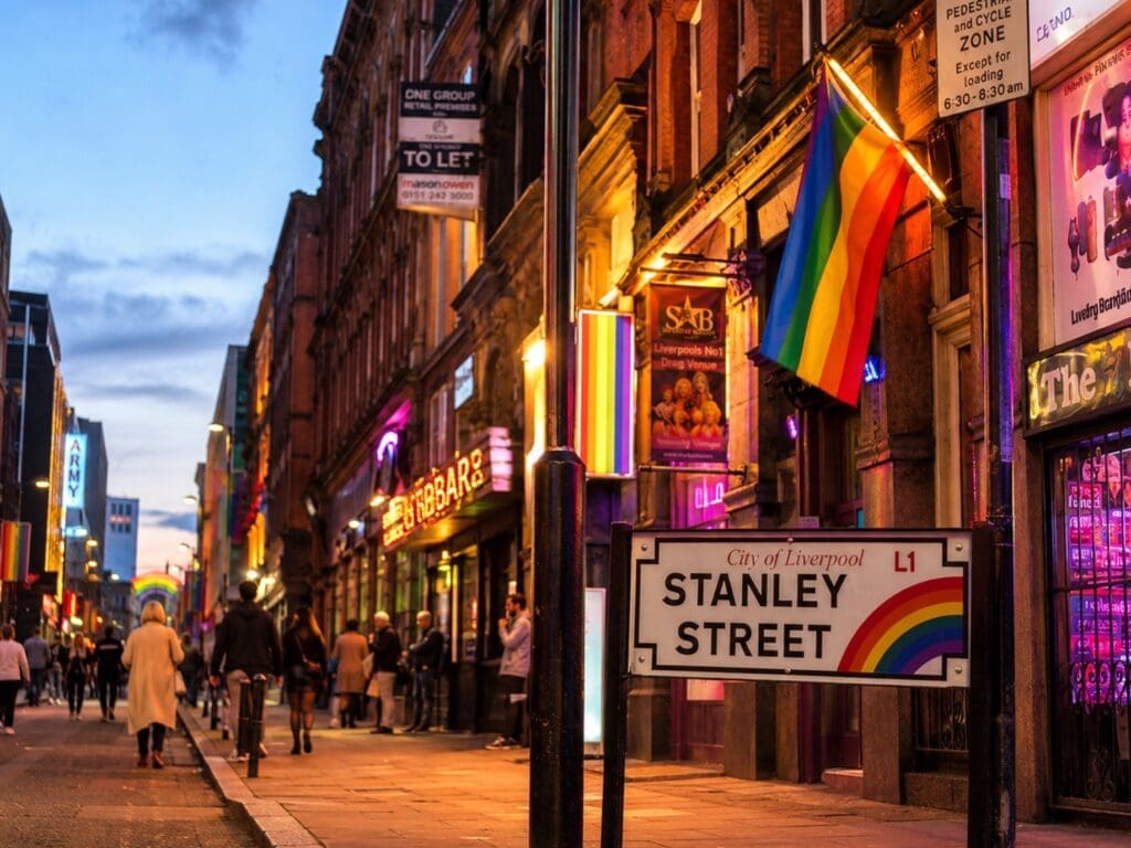Stanley Street in the early evening, with rainbow signage and warm venue lighting
