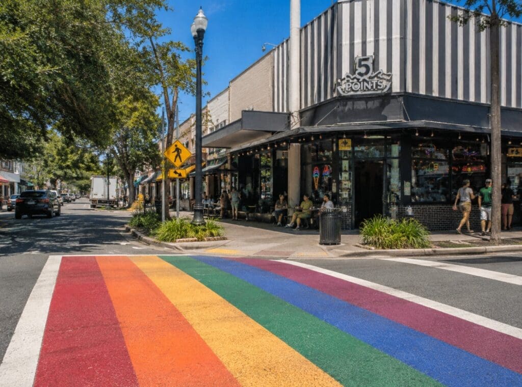 a high-quality street photo of Five Points with rainbow crosswalks and local storefronts