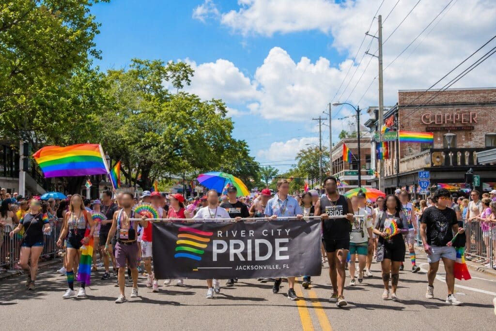 a photo of the River City Pride parade in Riverside or Five Points, with crowd consent and anonymized faces where needed