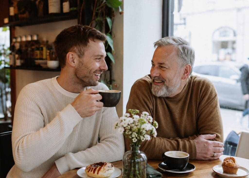 authentic photo of an older and younger queer couple enjoying a coffee date