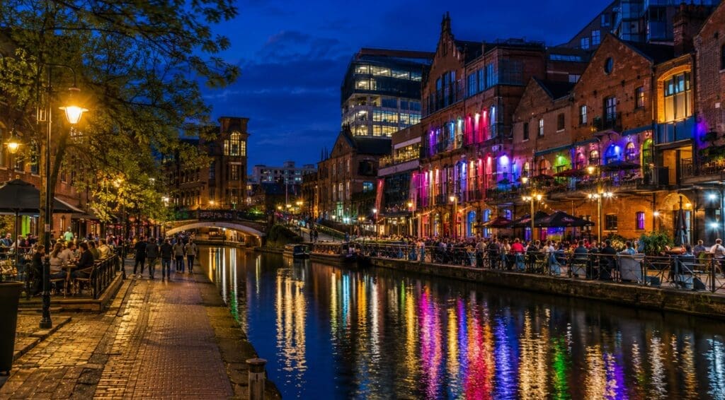 evening photograph of Canal Street with lights reflected in the canal (Manchester)