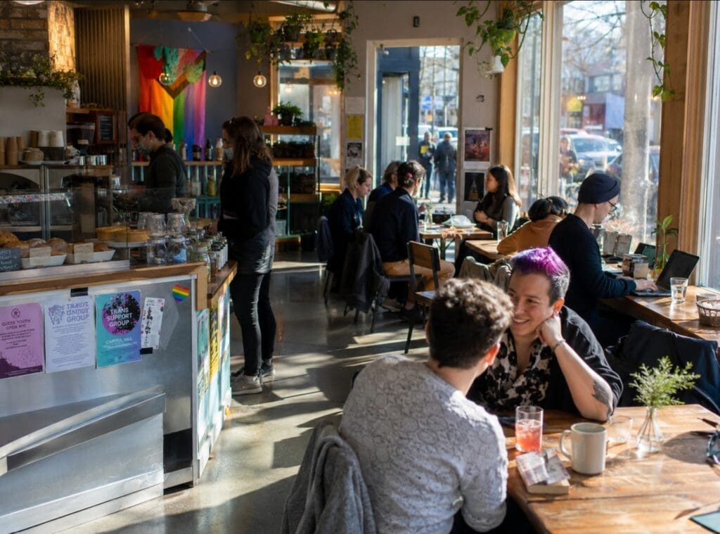 original photograph showing a bustling, inclusive coffee shop in Capitol Hill, Seattle