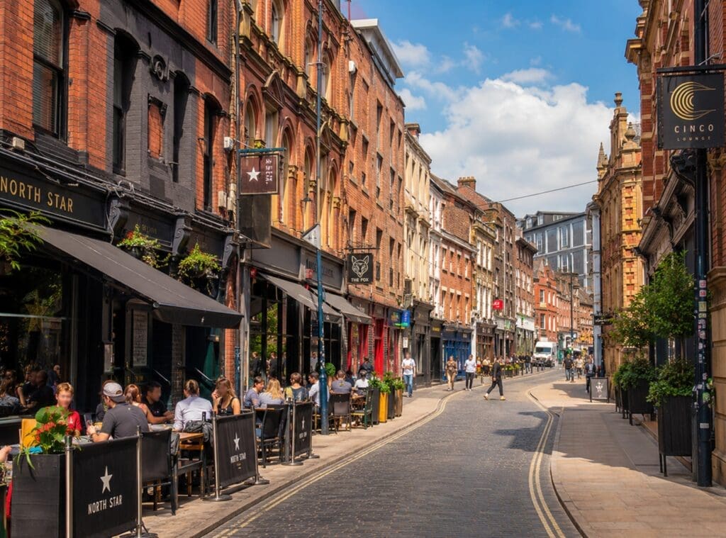 photograph of Call Lane during daytime, with brick buildings, street lifes