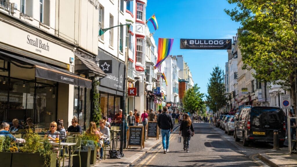 photograph of St James’s Street during the day, with cafés, flags and pedestrians seen from a respectful distance