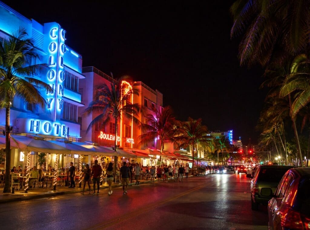 photograph of Washington Avenue or a South Beach nightlife street scene, with venue lights