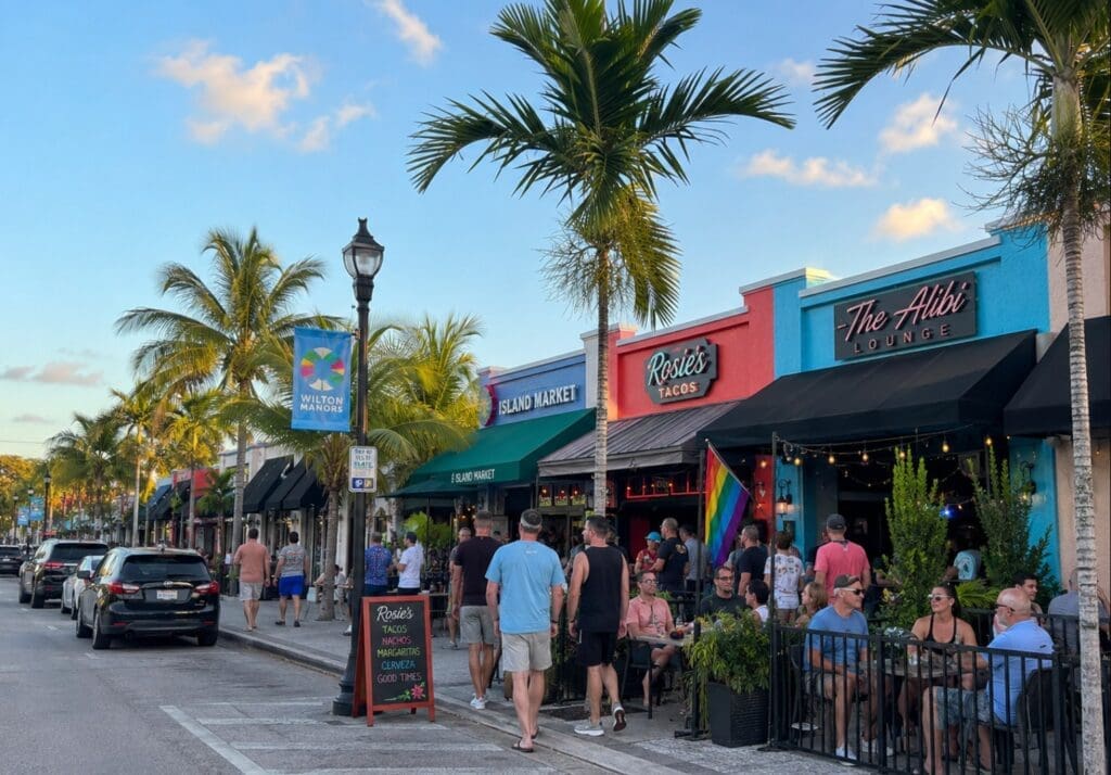 street-level image of Wilton Drive showing restaurants, bars, and pedestrian